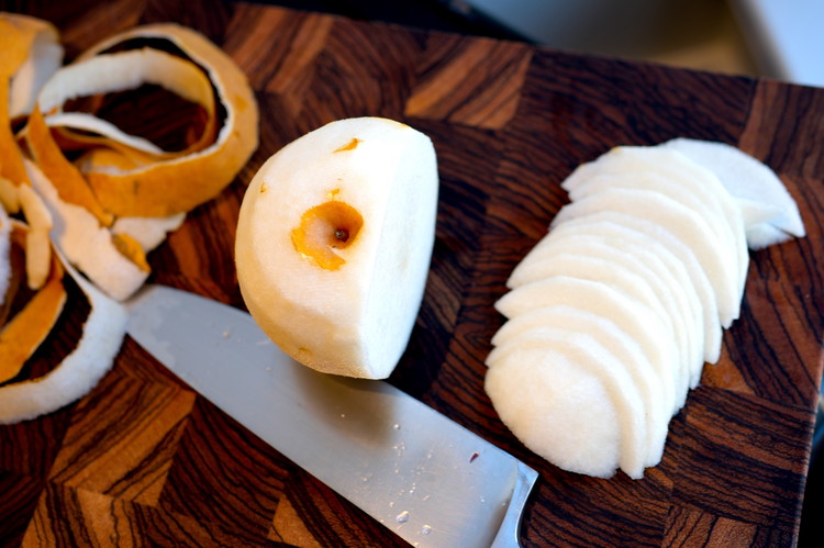 Image of Peel and cut the Asian pear into thin half moon slices.  Using Asian pears adds a wonderful texture to the salad