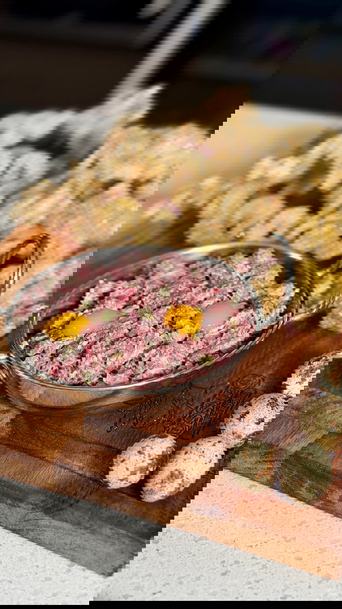 Image of for serving, separate the egg white from the yolk and place the quail yolks on top, that can be mixed in. 