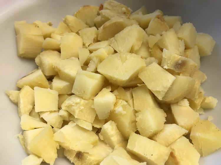Image of At dinner time, peel and cut the potatoes into chunks and place in a bowl. The skin should slide off easily. 