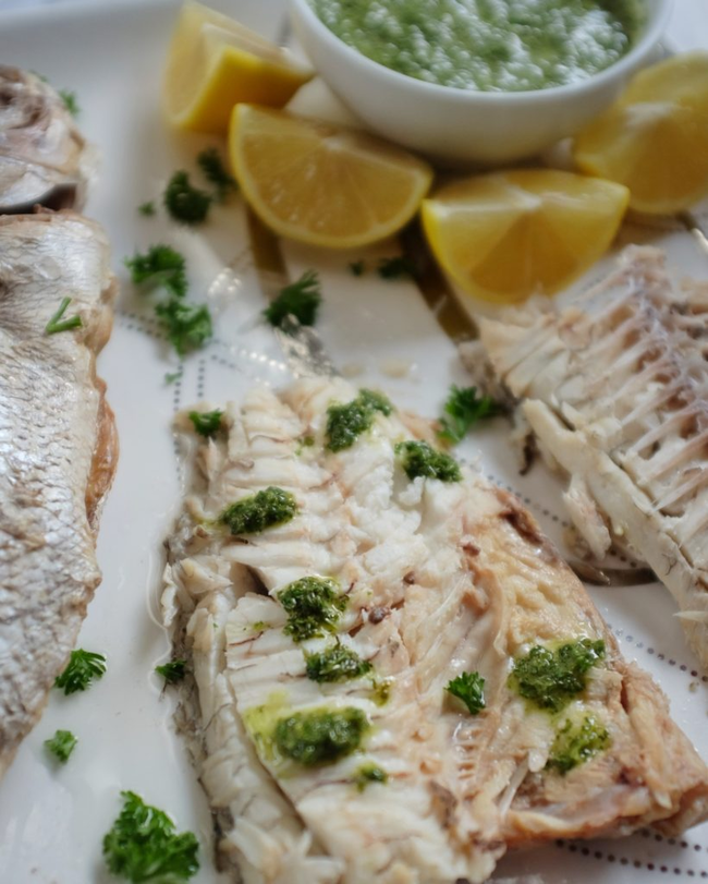 Image of Whole snapper in the oven with a Greek dressing