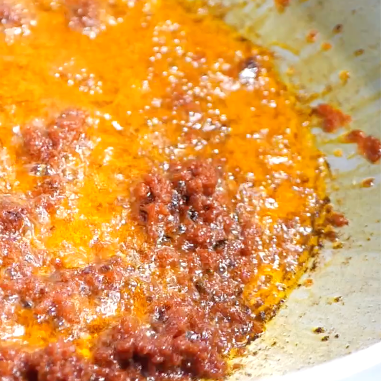 Image of Add ½ cup of oil and tomato paste to a...