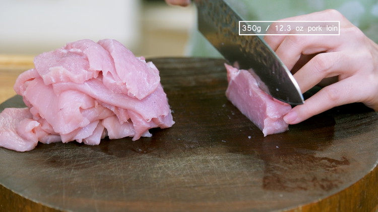Image of Slice the pork loin into ⅛-inch thick slices. Souped Up Swap: While this recipe is traditionally made with pork loin, pork belly also works; it is even more crunchy and delicious.