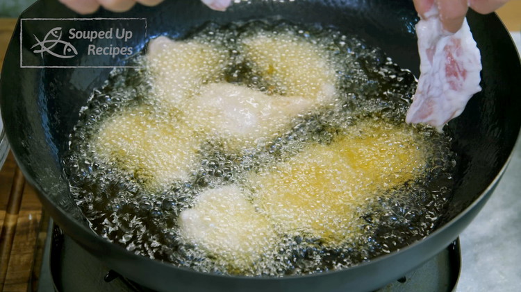 Image of Add oil to a wok and bring it to 380°F / 193°C over medium heat. Unfold the pork slices and drop them in the oil one by one. Fry them for a few minutes or until they are lightly golden. Chef’s Secret: It is best...