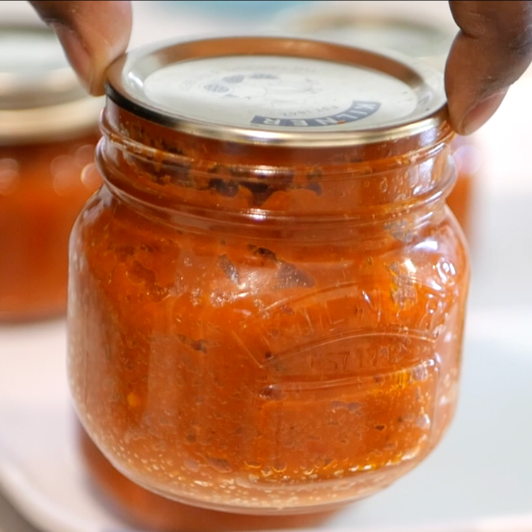Image of Check that the lids have sealed properly. Lift the jar...