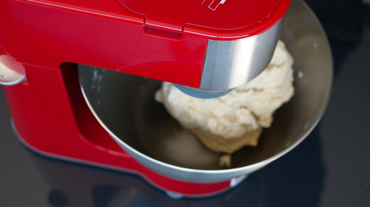 Image of Incorporate the flour and salt and into the wet  ingredients. Using a dough hook, mix the ingredients together on low speed.