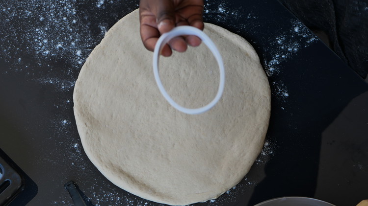 Image of Roll the dough onto you bench surface. Using a oval cookie cutter or and round bowl. Cut out ovular shaped dough. See the attached YouTube video for tips on how to achieve the signature ovular shape without a oval cutter....