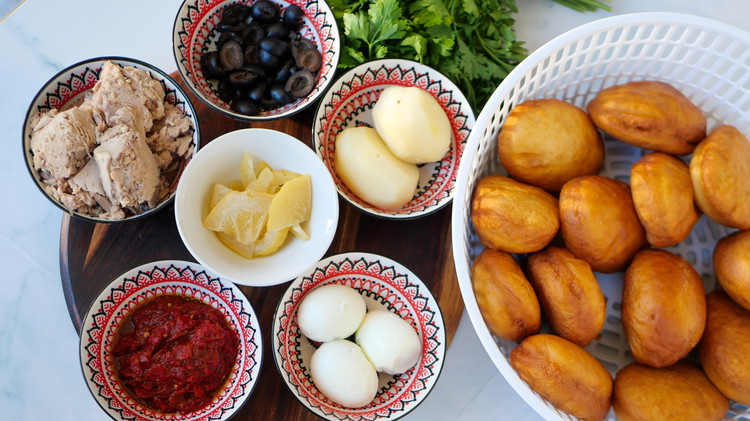 Image of Fill liberally with tuna, potatoes, egg, olives and parsley.