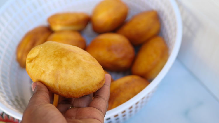 Image of Slice fried bun with a serrated knife making sure not...