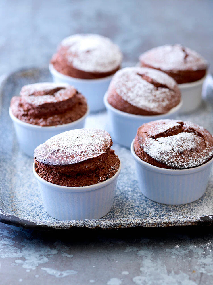 Easy hot chocolate soufflés with chocolate & cardamom sauce