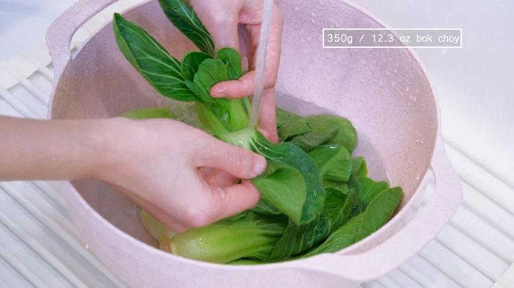 Image of Set the oven to 450 F. While waiting for the oven to preheat, rinse the bok choy. We will not tear the leaves apart so it is important to open the leaves and wash off the dirt in between. Drain...