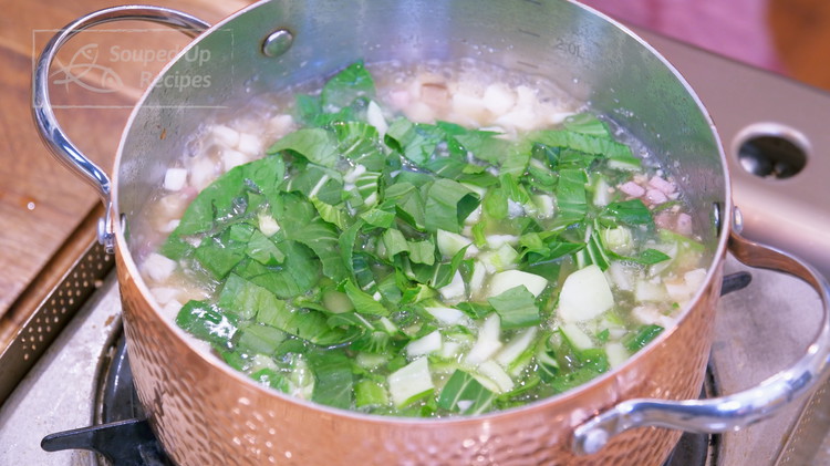 Image of Rinse 6 oz of baby bok choy and dice finely. Once the water comes to a boil, add the bok choy and let it cook for 15 seconds.