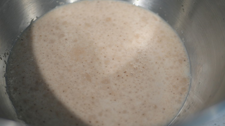Image of 1. In a large bowl, mix warm milk, yeast, and sugar. Let it sit for 5-10 minutes until foamy.