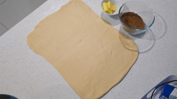 Image of Roll out the dough into a 35.5x22.8-cm / 14x9-inch rectangle on a floured surface.