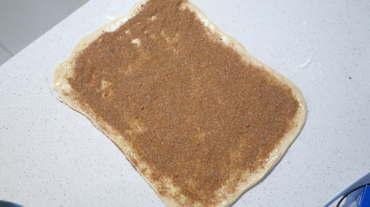 Image of Spread the softened butter over the dough, then sprinkle the cinnamon sugar evenly on top.