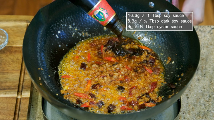 Image of Keep stirring until the oil turns into a golden red color, season it with 1 Tbsp of soy sauce, ½ Tbsp of dark soy sauce, and ½ Tbsp of oyster sauce. Stir over medium heat for a minute to slightly...