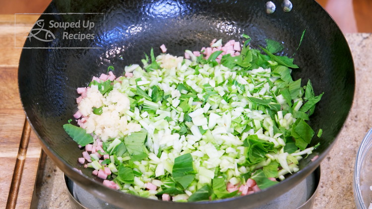 Image of Add the diced bok choy and 1.5 Tbsps of minced garlic. Stir for a couple of minutes.
