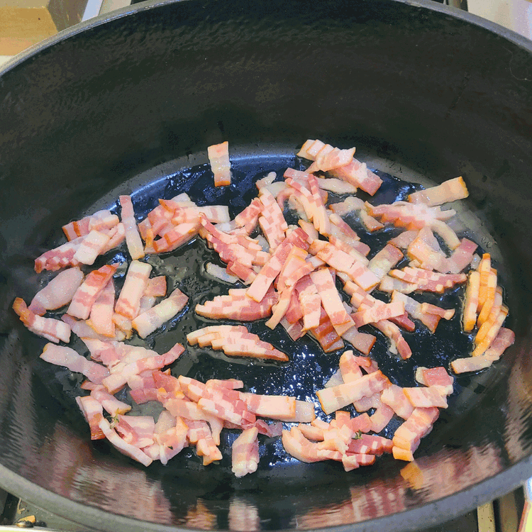 Image of Add a small amount of olive oil to your dutch oven and cook the bacon over medium heat, before setting aside.