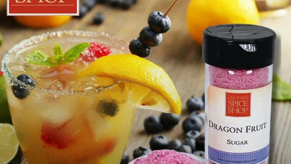 Glass of Berry Brunch Punch with Fruit and Dragon Fruit Sugar Rim.