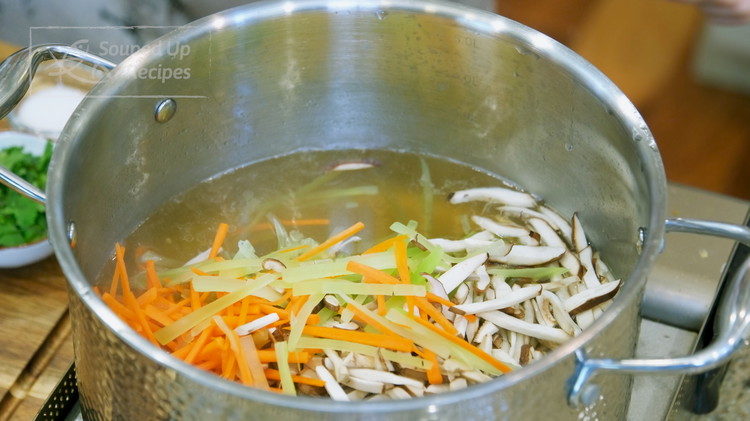 Image of Bring the broth to a boil again. Add all the julienned mushroom, carrot, ham and lettuce stem and cook for 1 minute.