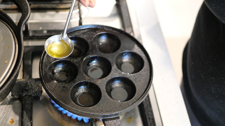 Image of Add oil to the heated pan and Pour small portions of the batter into the pan. Cook until bubbles form on the surface and the edges begin to set (about 2-3 minutes).