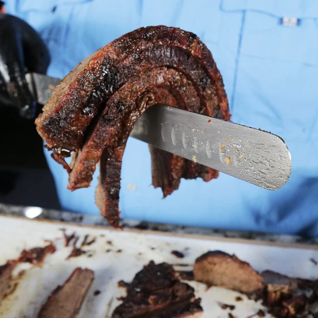 Brisket slices on a knife