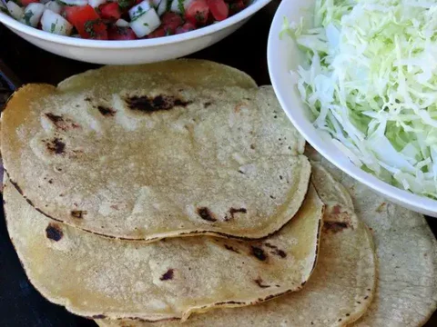 Image of Prep the cabbage, pico, avocado, limes, and tortillas, and set aside.