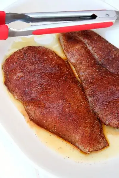 Image of Preheat grill over medium-high heat. Mix together all of the spices and evenly coat both sides of the chicken. Set aside to marinate for 30 minutes at room temperature (optional).