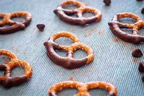 Image of Set chocolate-covered pretzels to the side to sit for 30 minutes.