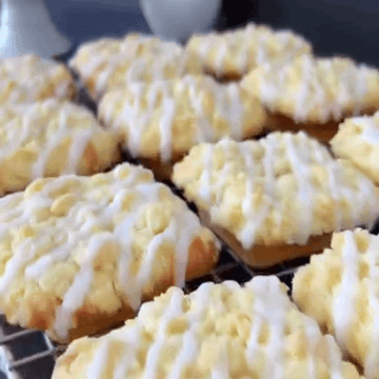 Image of Drizzle the glaze over the cooled mini cakes using a...