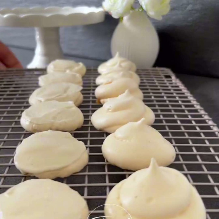 Image of Associez les moitiés de meringue par taille. Prenez une moitié de meringue et étalez une quantité généreuse de crème fouettée sur le côté plat. Ajoutez une seconde moitié de meringue (côté plat vers le bas) pour former un petit sandwich...