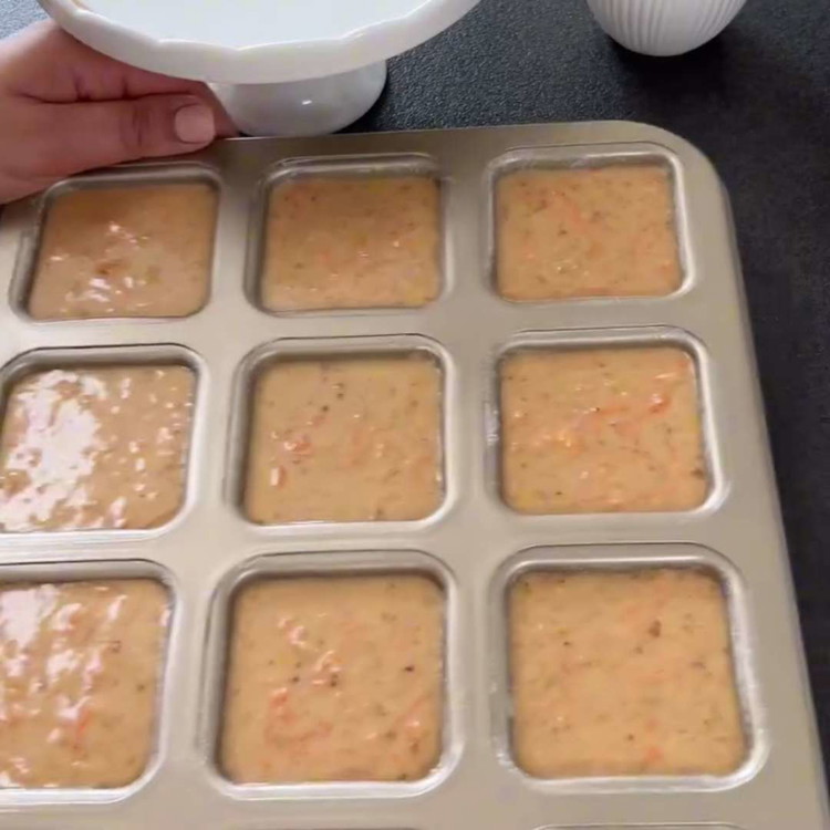 Image of Divide the batter evenly among the 12 muffin molds, filling each about two-thirds full
