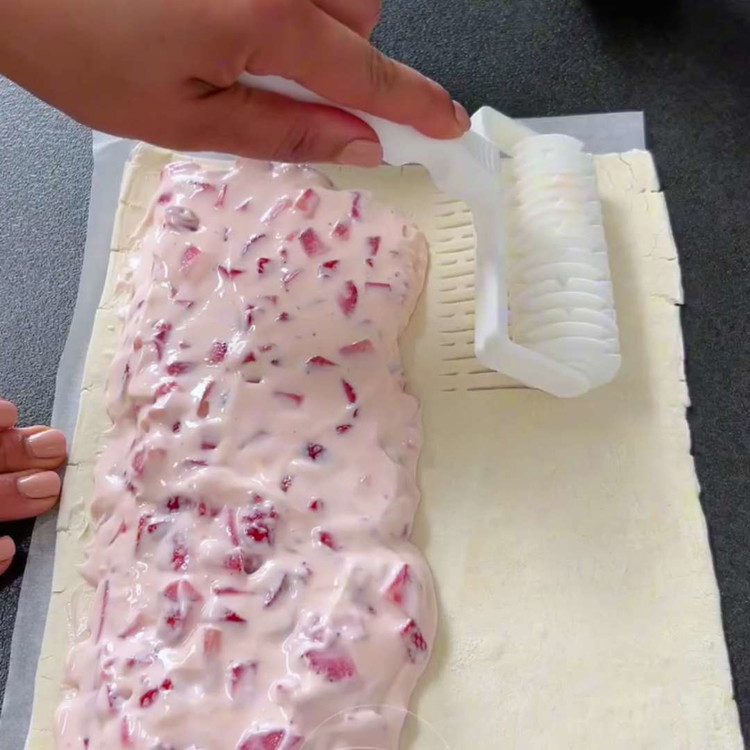 Image of Verwenden Sie einen Musterroller auf der leeren Seite des Blätterteigs und klappen Sie ihn dann über die Füllung. Drücken Sie die Ränder gut zusammen, um sie mit einer Gabel zu versiegeln.