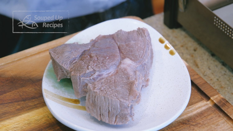 Image of Once the water comes to a boil, remove the beef from the pot, discard the blanching water, and set the beef aside.