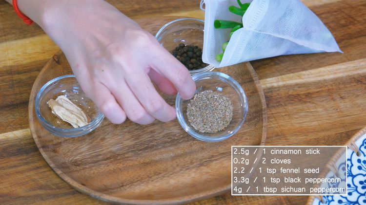 Image of Meanwhile, add the cinnamon stick, cloves, fennel seed, black peppercorns, licorice root, Sichuan peppercorns, garlic cloves, ginger slices, and scallion stalks into a spice bag.