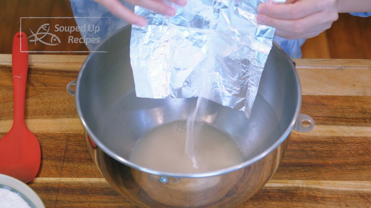 Image of Add the sodium carbonate to the yeast water and stir...