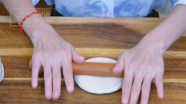 Image of Flatten one piece of the cylinder and roll it into a thick round patty, about 3.5 inches in diameter. Set it aside and apply the same technique to the rest of the dough pieces.