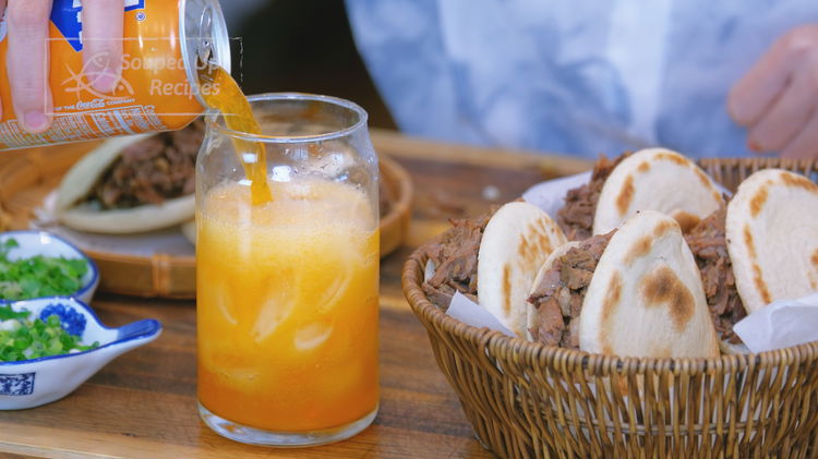 Image of Enjoy your rou jia mo with orange soda.