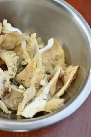 Image of Cut or tear the mushrooms by hand into long stripes.