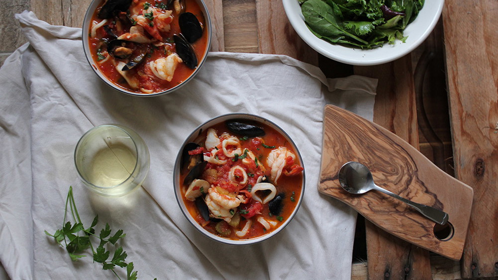 Image of California Seafood Recipe: California Cioppino with Avocado, Goat Cheese and Arugula Salad