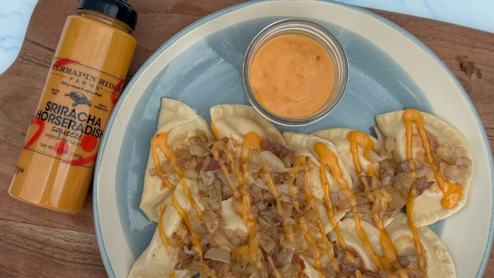 Image of Loaded Pierogies with Sriracha Horseradish Garnishing Squeeze