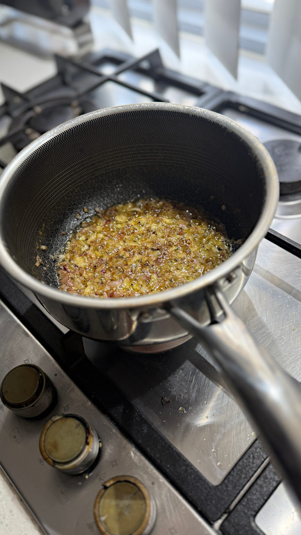 Image of Whilst they are resting, start on the sauce. Sautée garlic and onion in the butter (until soft and translucent), then add remaining ingredients. Cook peas until soft