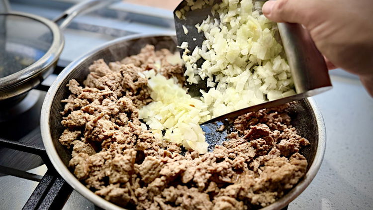 Image of clear a spot in the middle and cook onion and...