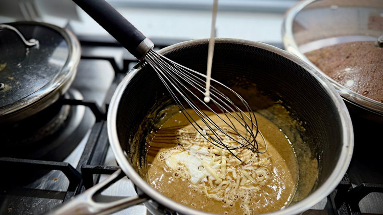Image of into a pot on low-medium heat heat, add your butter. once melted and slightly bubbling add your flour and mix. It should be like a thick paste with a slightly brown colour to it and smell slightly nutty. 