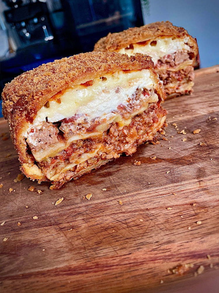 Image of Heat veggie oil in deep fryer or pot to 140C, then carefully lower crumbed lasagne in and cook until slightly brown. Slowly raise temp over 10 mins or so until you reach 165C. The exterior should be a dark golden...