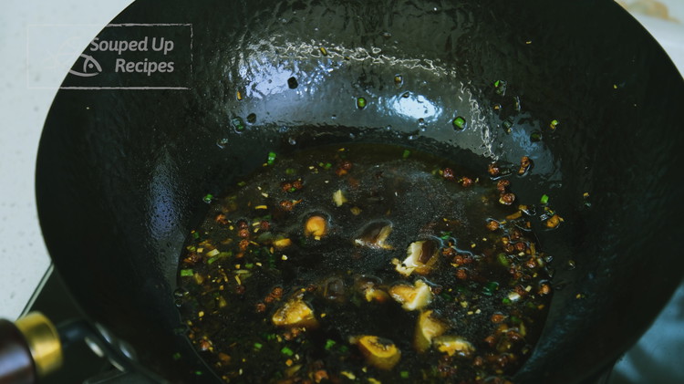 Image of Add the soy sauce, fish sauce, oyster sauce, sugar, and the soaked mushroom, along with its soaking water, and stir well.
