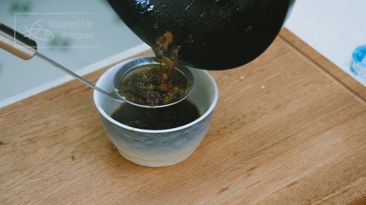 Image of Let the sauce go through a sieve to eliminate all the solid ingredients. Set the sauce aside.