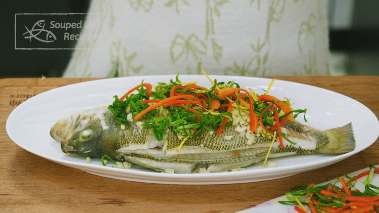 Image of Transfer the fish to a clean serving plate; then place the soaked julienned scallion, ginger, red chili, and minced garlic on top of the fish.