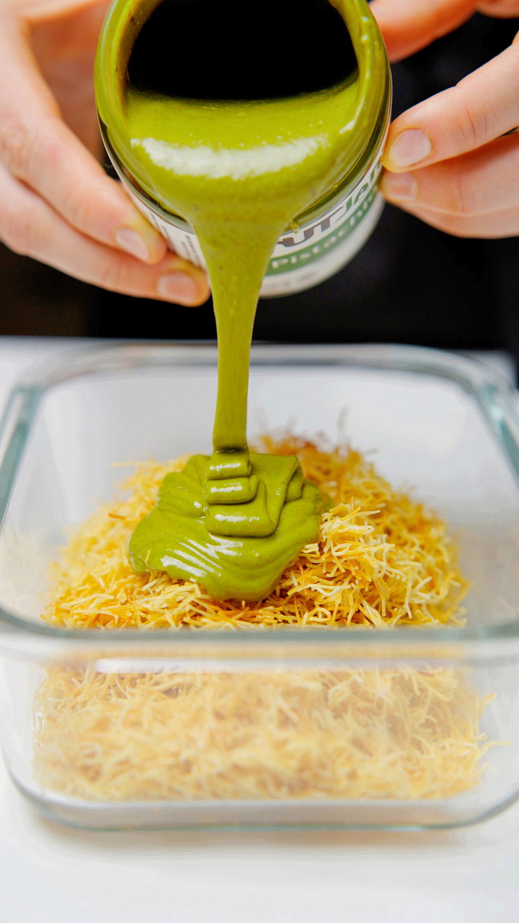 Image of Once the kataifi base has cooled, gently mix it with the pistachio filling.  Set the mixture aside.
