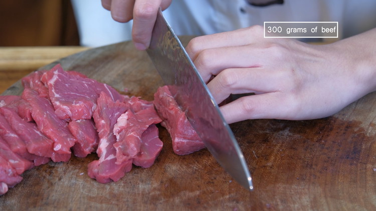Image of Slice the beef into 1/4 of an inch thick pieces. I am using top sirlion today. Other tender cuts such as ribeye, flank steak, round steak, and beef chuck will also work. 