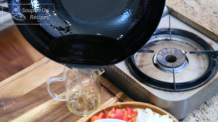 Image of Once all the beef is done frying, pour most of the oil out and leave about 2 tbsp of oil in the wok.